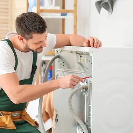 Technician checking a washing machine water-supply hose